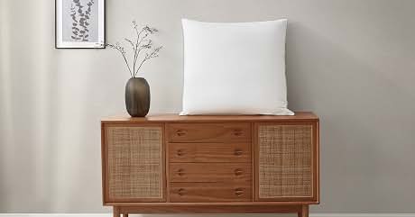a sideboard with a white pillow on top of it.